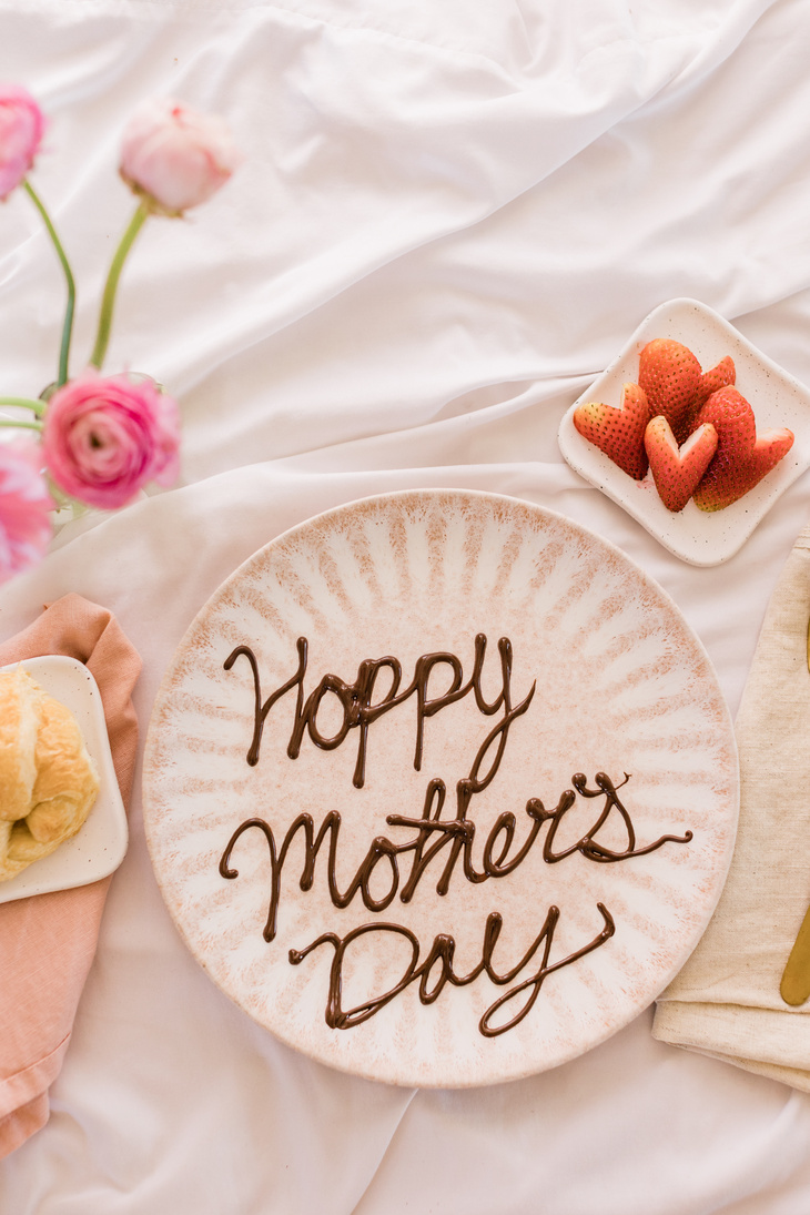 Happy Mother's Day Written on Plate with Breakfast in Bed